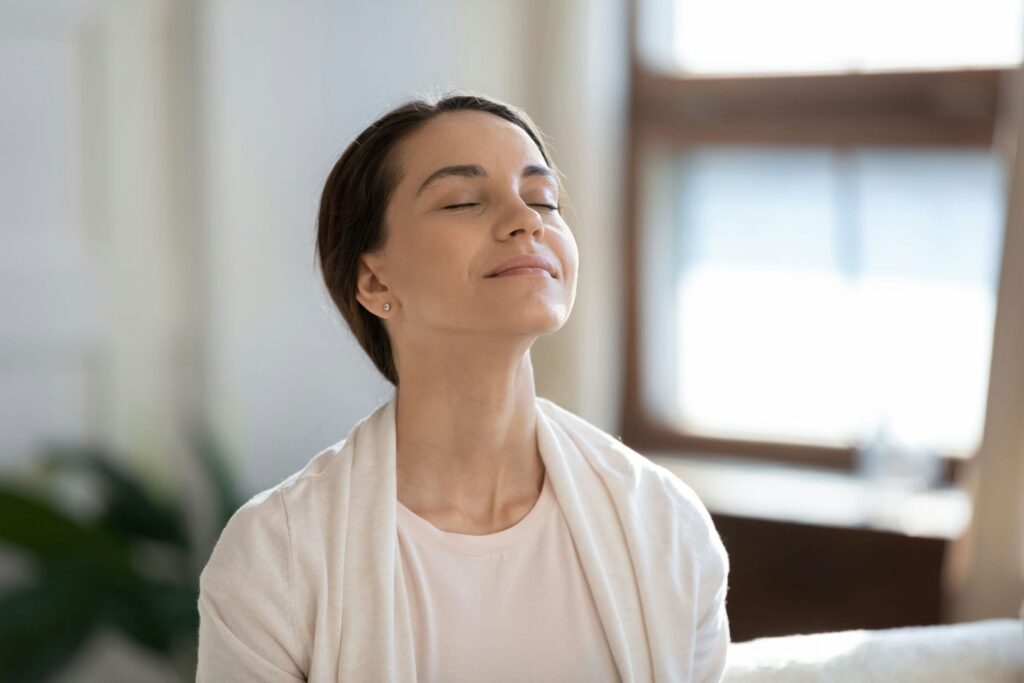 content woman breathing clean air in custom home