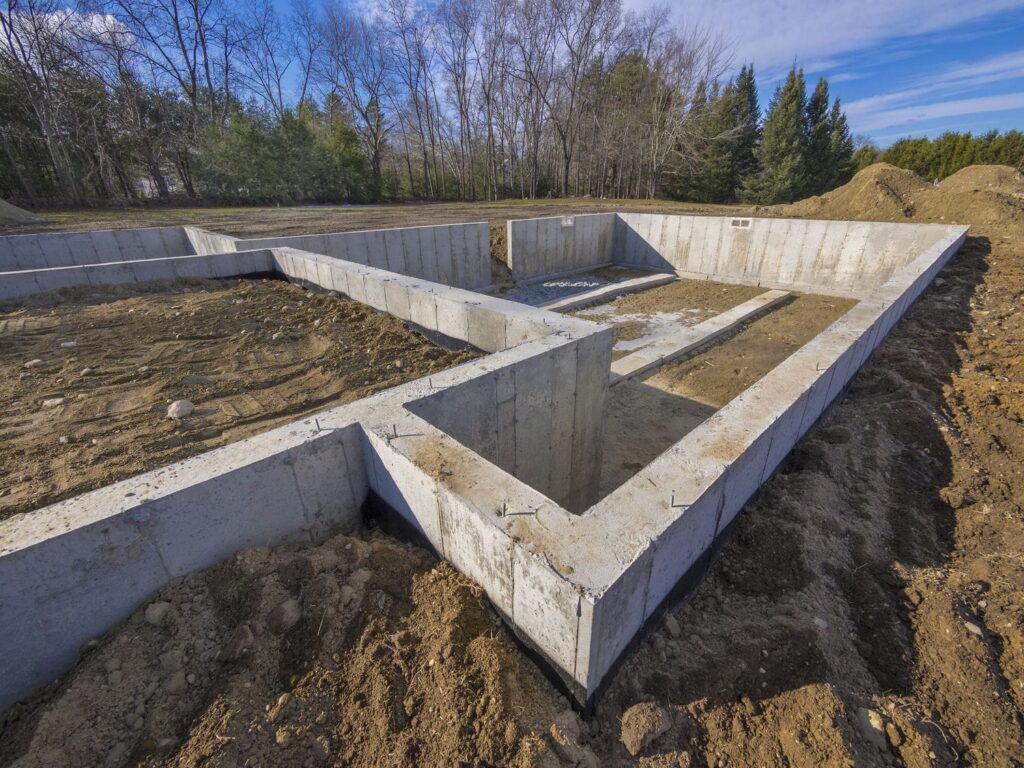Poured concrete foundation walls for a new custom home on a prepared residential lot