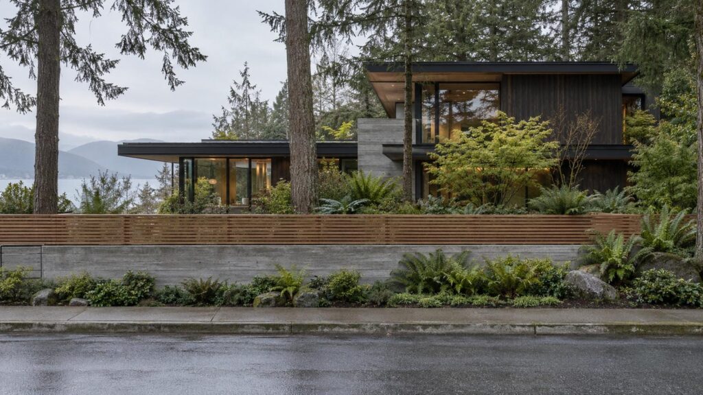 Low concrete wall and cedar fence along the street frontage of a West Coast contemporary custom home in Greater Vancouver