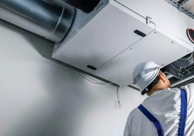 hvac contractor working on HRV system